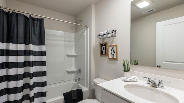 bathroom with visible vents, vanity, shower / tub combo, and toilet