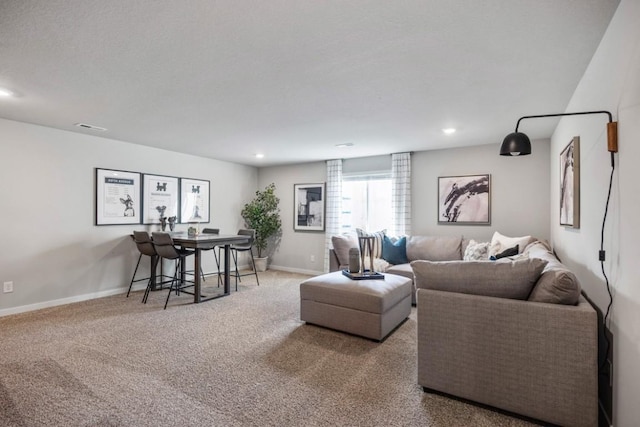 carpeted living area with recessed lighting, visible vents, and baseboards