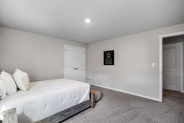 carpeted bedroom with baseboards, visible vents, and a closet