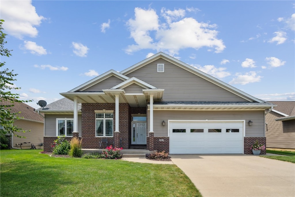 craftsman house with a garage and a front yard