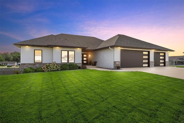 prairie-style house with a yard and a garage