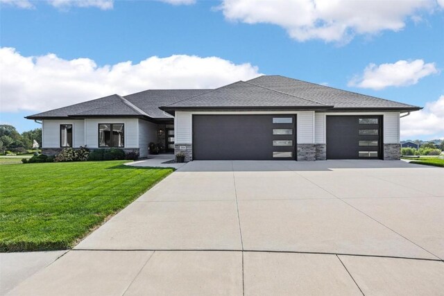 prairie-style house featuring a front yard and a garage