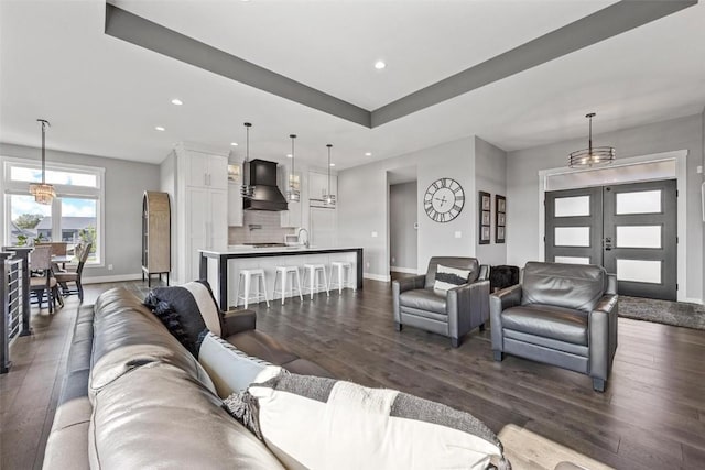 living room with dark wood-style floors, french doors, recessed lighting, and baseboards