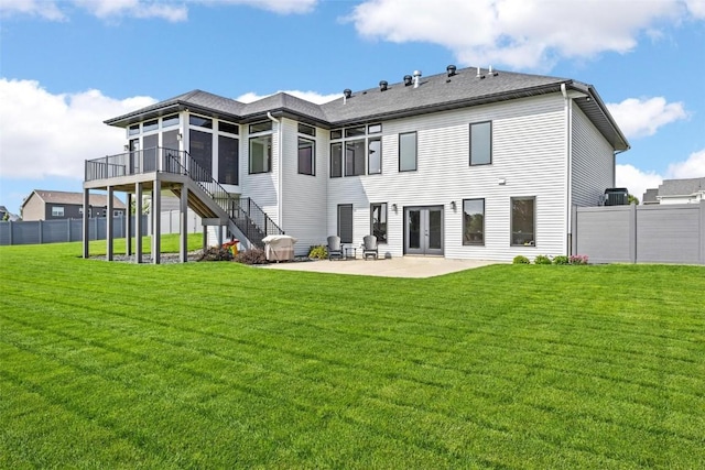 back of property featuring a patio area, fence, stairway, and a yard