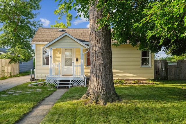 bungalow-style house featuring a front yard