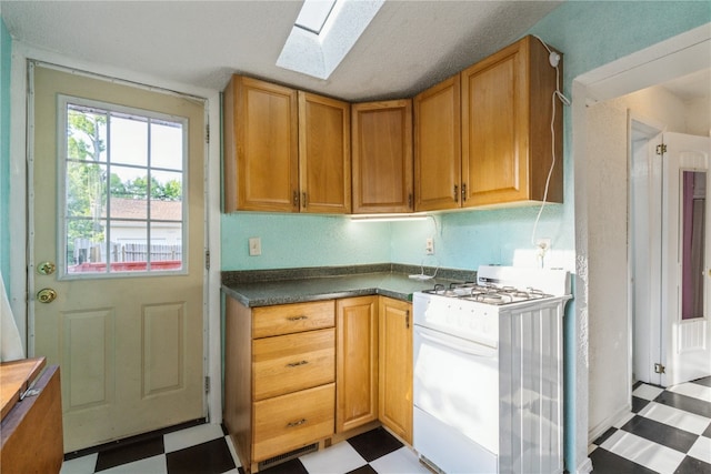 kitchen featuring white range with gas cooktop