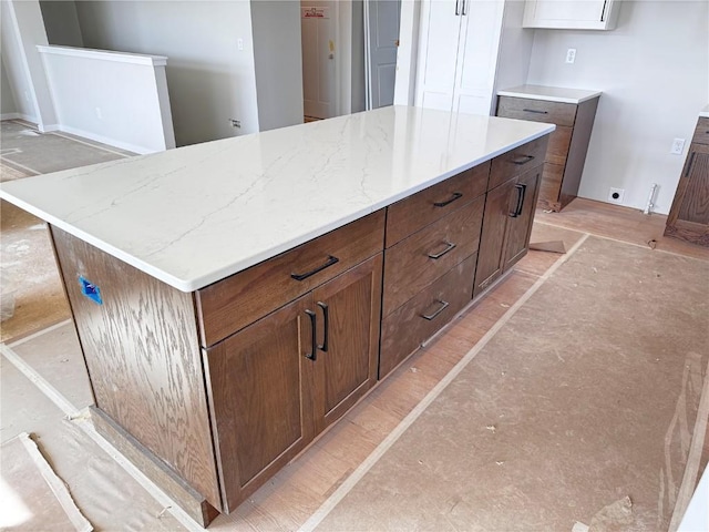 kitchen with light stone counters and a kitchen island