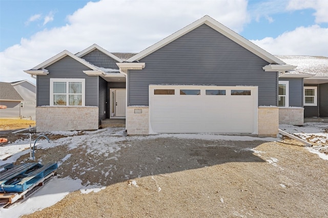 view of front facade featuring stone siding and an attached garage