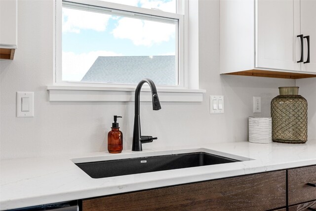5638 Meadow Grass Cir SE, Cedar Rapids, IA 52403 - kitchen view of a sink, white cabinets, and light stone counters