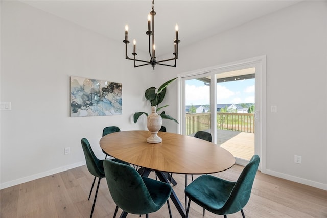 5638 Meadow Grass Cir SE, Cedar Rapids, IA 52403 - dining space featuring a chandelier, light wood-style floors, and baseboards