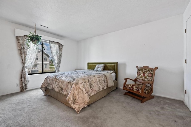 carpeted bedroom featuring a textured ceiling