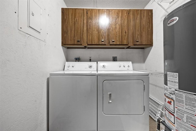 clothes washing area featuring gas water heater, cabinet space, a textured wall, washer and dryer, and electric panel