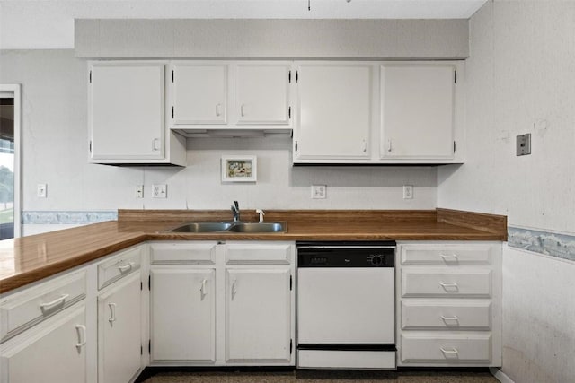 kitchen with a sink, dark countertops, white cabinets, and dishwasher