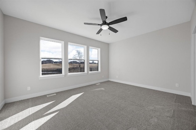 unfurnished room with ceiling fan and carpet floors