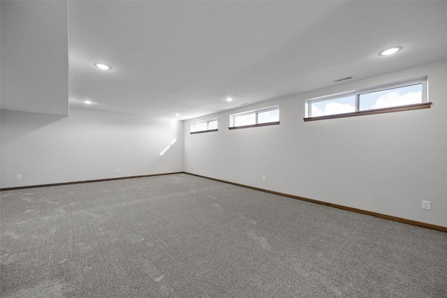 basement with carpet flooring and a healthy amount of sunlight