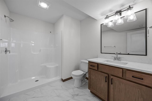 bathroom featuring toilet, a shower, and vanity