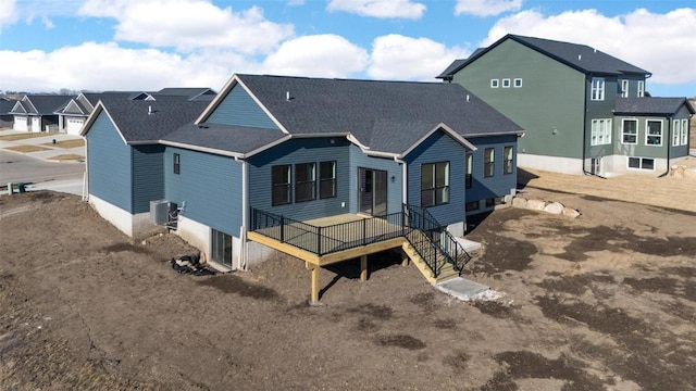 back of property with a deck and central air condition unit