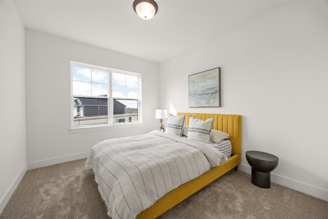 carpeted bedroom featuring baseboards