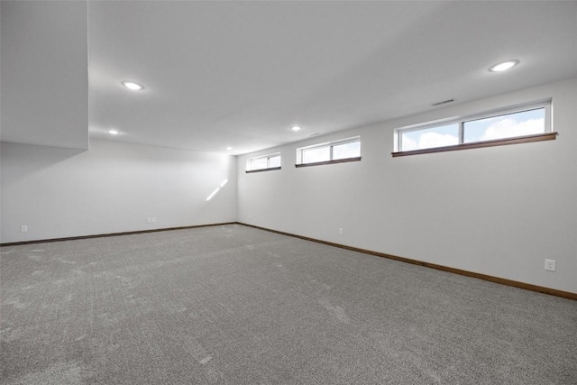 below grade area with recessed lighting, carpet floors, and baseboards