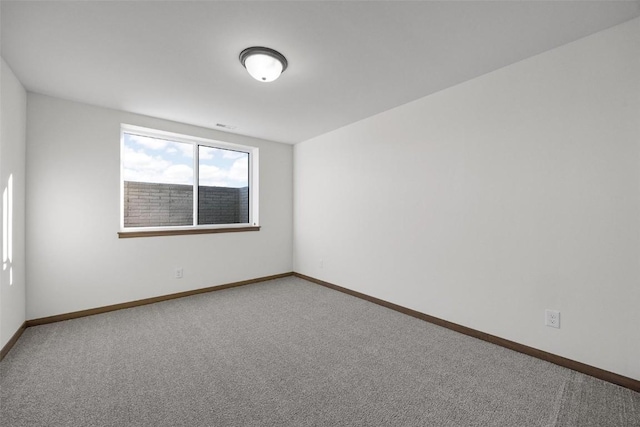 empty room with baseboards and carpet floors