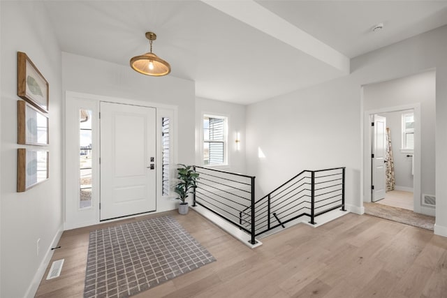 entryway featuring visible vents, a wealth of natural light, and wood finished floors