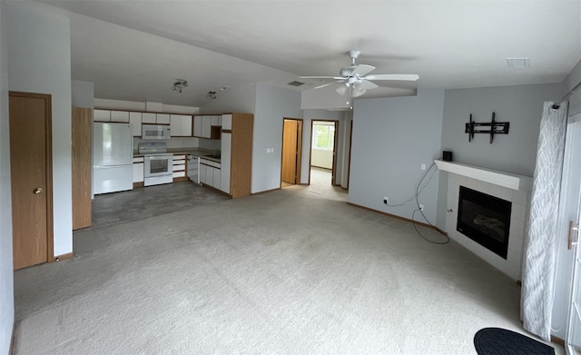 unfurnished living room featuring ceiling fan and light carpet