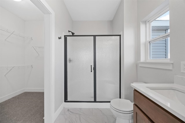 bathroom featuring vanity, toilet, and walk in shower