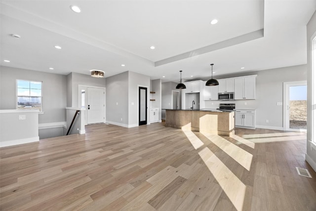 unfurnished living room with light hardwood / wood-style flooring