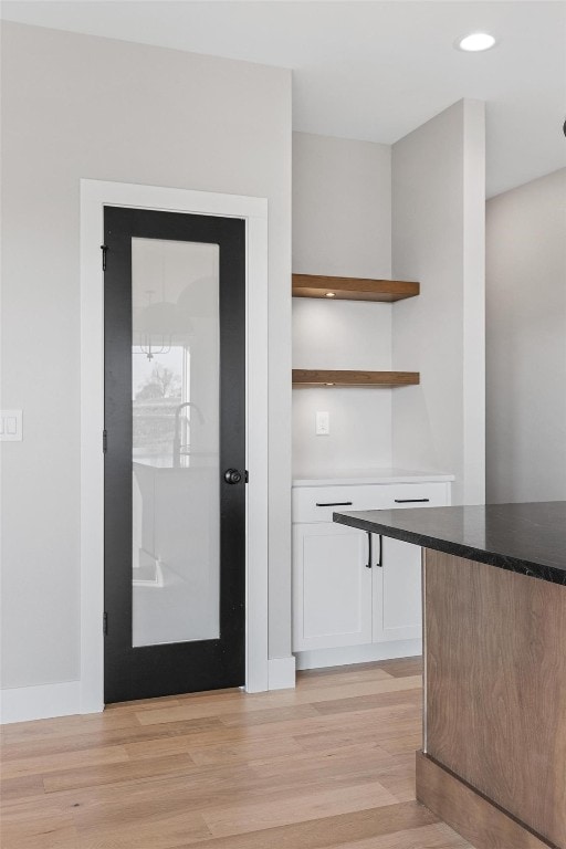 interior space featuring white cabinetry and light hardwood / wood-style flooring