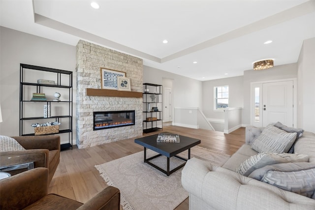 1510 Cardinal Dr, Fairfax, IA 52228 - living room featuring wood finished floors, a fireplace, baseboards, recessed lighting, and a tray ceiling