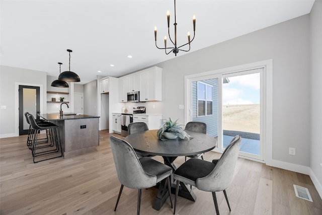 1510 Cardinal Dr, Fairfax, IA 52228 - dining room featuring a chandelier, light wood-type flooring, baseboards, and recessed lighting