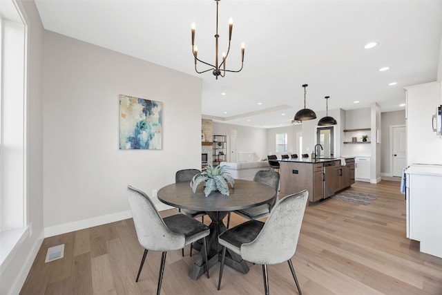 1510 Cardinal Dr, Fairfax, IA 52228 - dining space with light wood-type flooring, recessed lighting, a chandelier, and baseboards