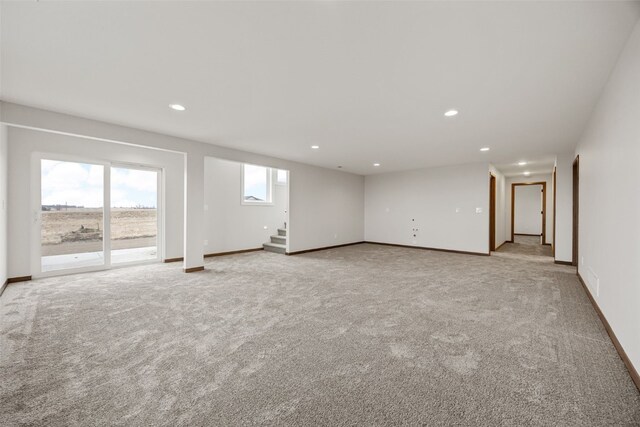 1519 Cardinal Dr, Fairfax, IA 52228 - empty room with stairs, recessed lighting, and light carpet