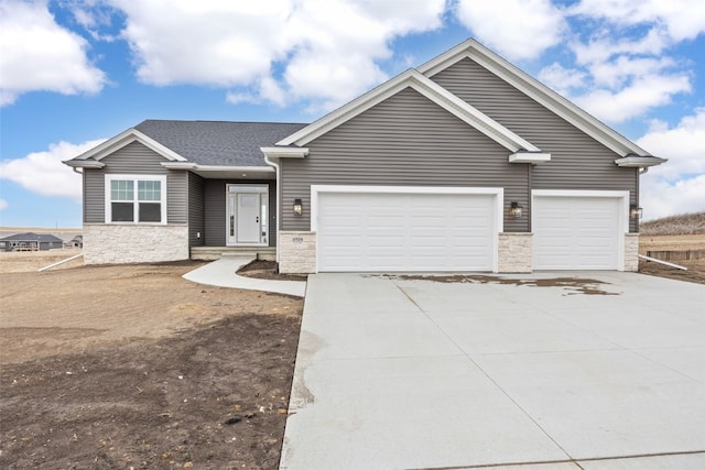 view of front facade with a garage, stone siding, concrete driveway, and roof with shingles