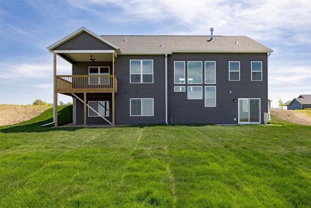 1519 Cardinal Dr, Fairfax, IA 52228 - rear view of house featuring a lawn, ceiling fan, and a deck
