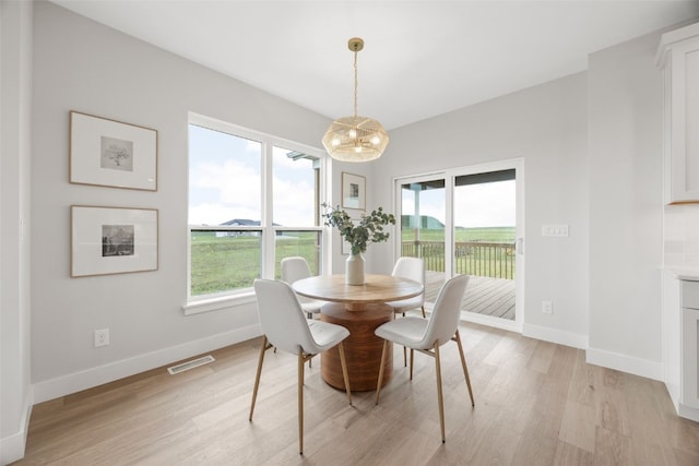 1519 Cardinal Dr, Fairfax, IA 52228 - dining area with light wood-style floors, a chandelier, and plenty of natural light