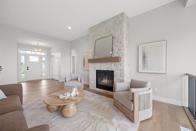 1519 Cardinal Dr, Fairfax, IA 52228 - living area with light wood finished floors, a fireplace, and recessed lighting