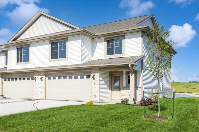 view of front of house featuring a front yard and a garage