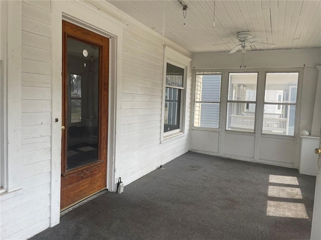 unfurnished sunroom with ceiling fan