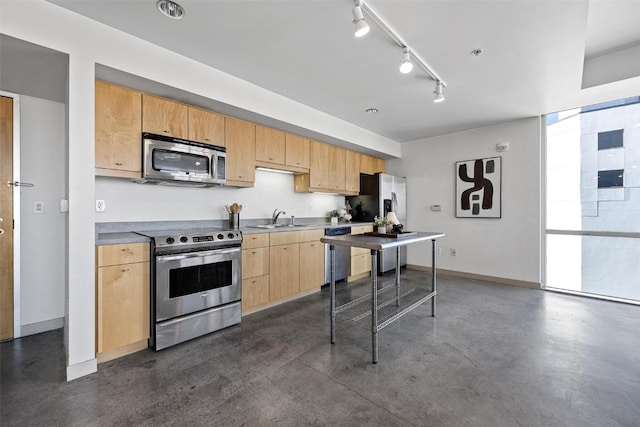 kitchen with track lighting, light brown cabinetry, stainless steel appliances, and sink