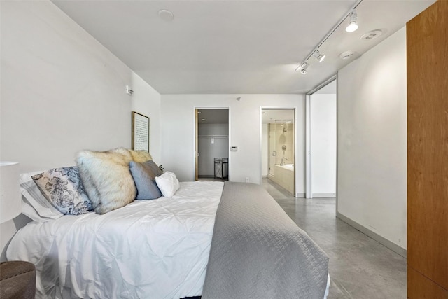 bedroom with rail lighting and ensuite bathroom