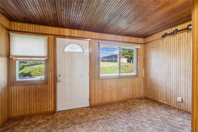 entryway with wooden walls and wooden ceiling