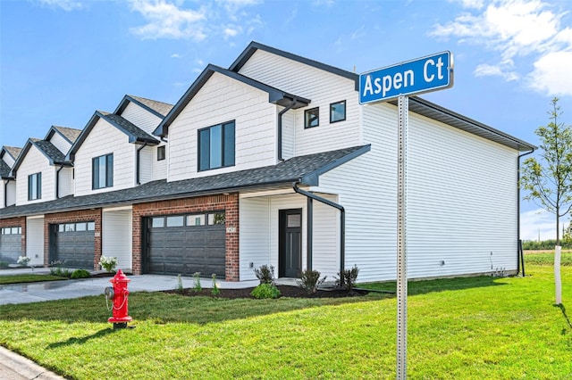 view of front of property featuring a garage and a front lawn