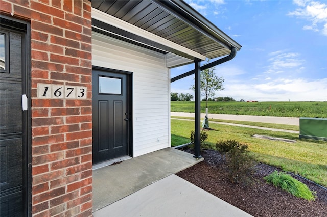 entrance to property featuring a yard