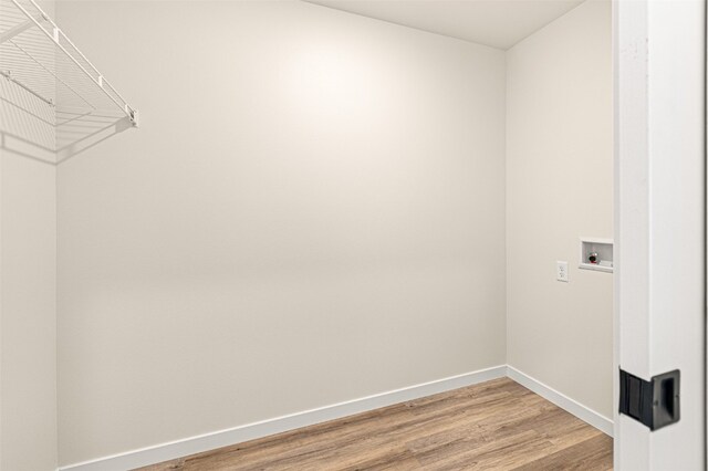 washroom featuring hookup for a washing machine and light hardwood / wood-style flooring