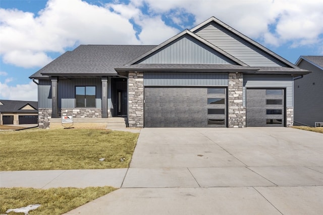 view of front of property with a garage and a front lawn