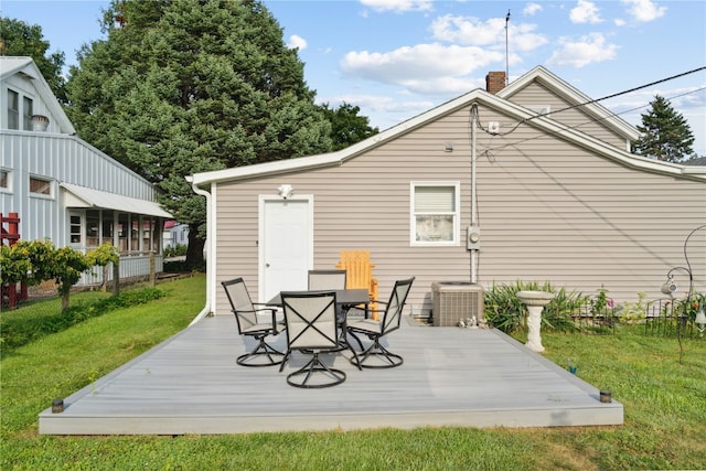 rear view of house with a wooden deck, a lawn, and central AC unit