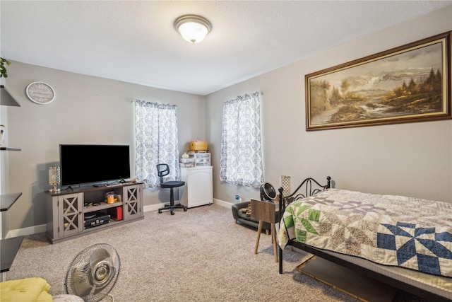 bedroom featuring light carpet and a textured ceiling