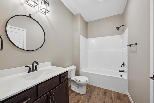 full bathroom with shower / washtub combination, hardwood / wood-style floors, vanity, and toilet