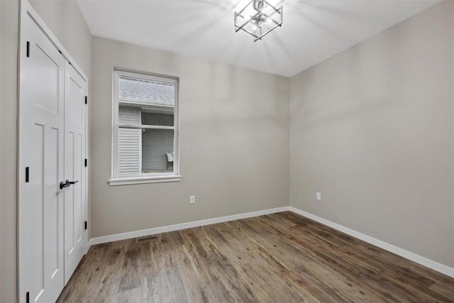 unfurnished room with hardwood / wood-style floors